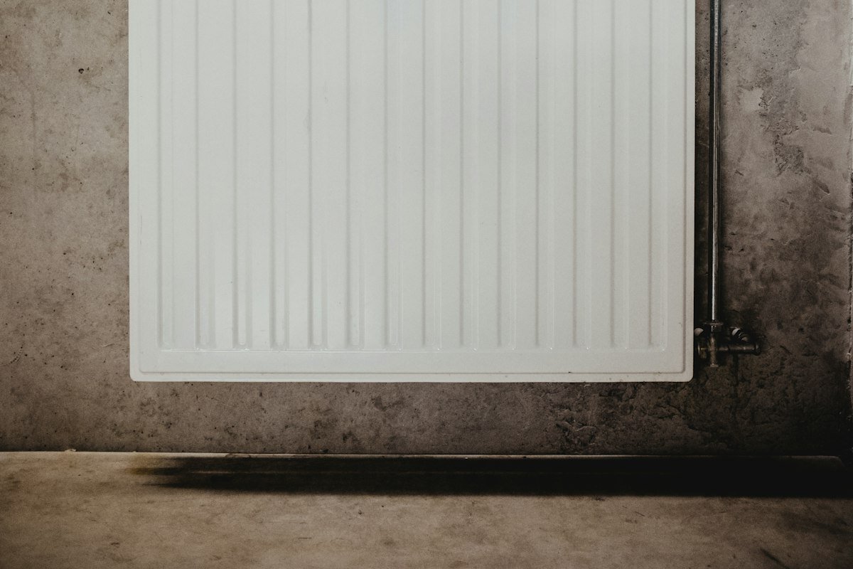 Radiador de paneles blanco en una pared de hormigón