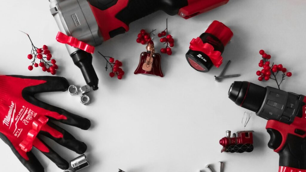 Herramientas eléctricas y guantes de trabajo entre adornos de Navidad